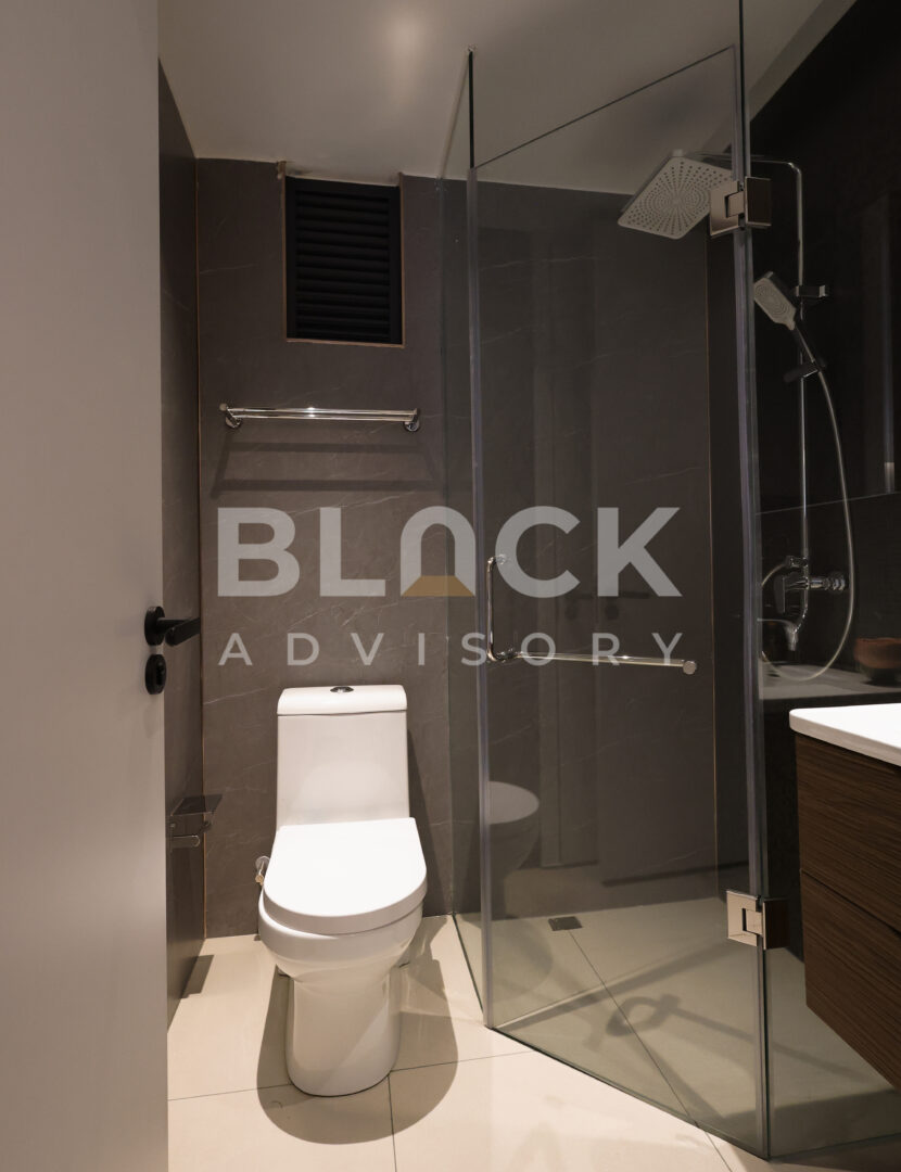 Amani Residence show apartment bathroom with a glass shower enclosure and a wall-hung vanity