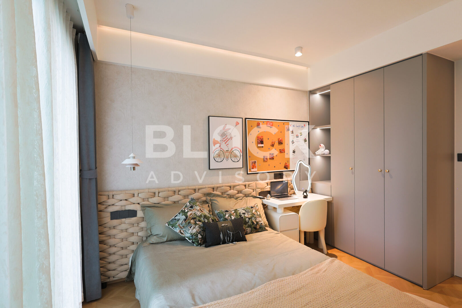 Amani Residence show apartment bedroom with a desk, fitted wardrobes and framed prints