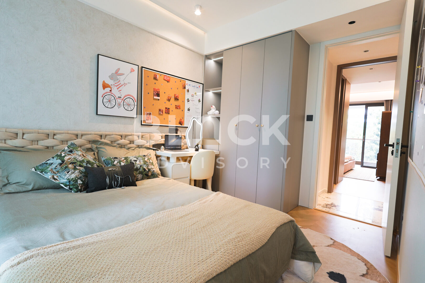 Amani Residence show apartment bedroom with fitted wardrobes and a door to the hallway