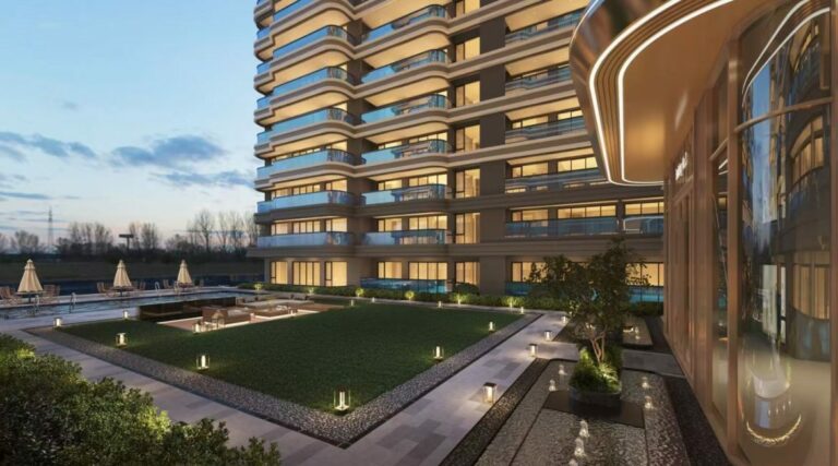 Project render of the Riverside Azure apartment tower at dusk above a landscaped garden courtyard