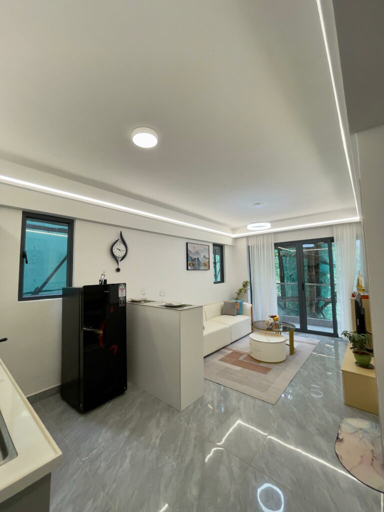 Serene Manor show apartment living room with sofa and sliding doors to the balcony