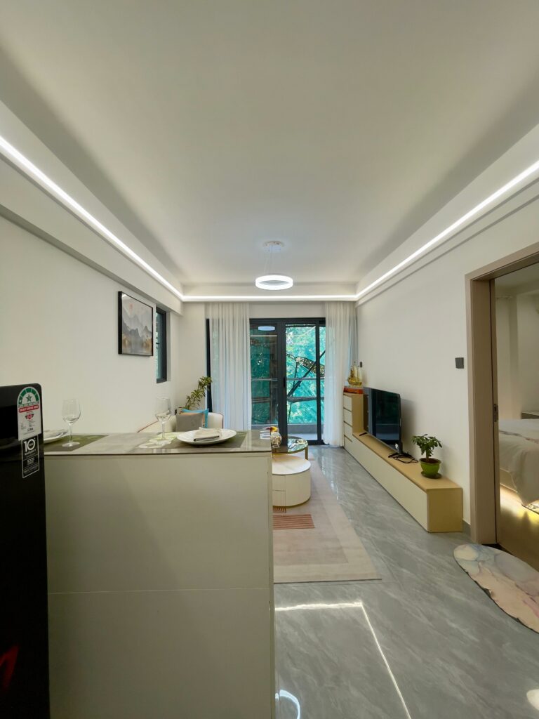 Serene Manor show apartment open-plan living area with kitchen counter and balcony door