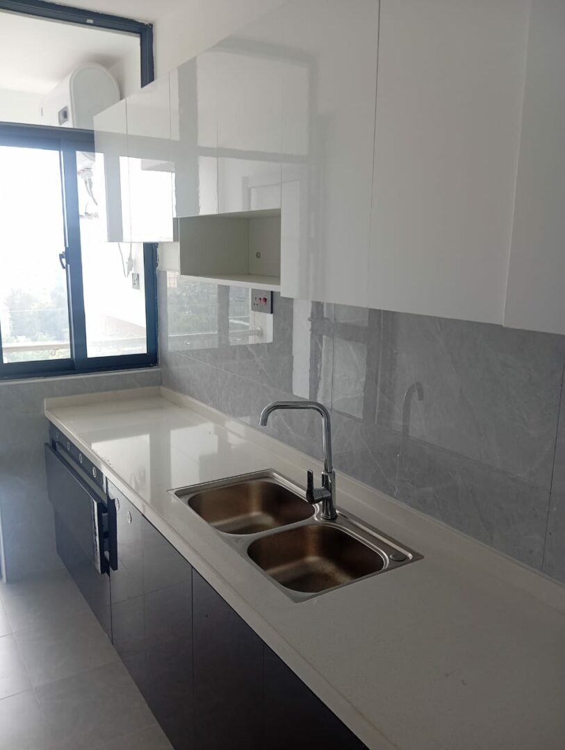Serenity Residency Modern fitted kitchen with sleek, functional finishes.