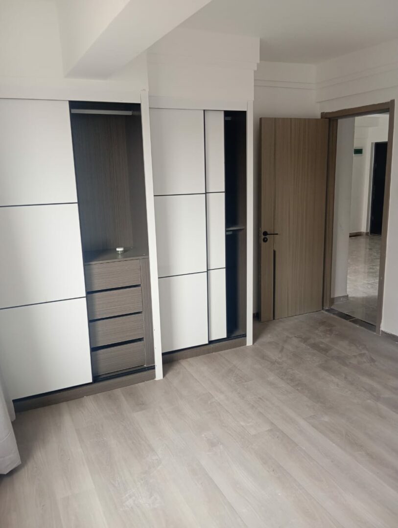 Polaris Residency Spacious bedroom with built-in wardrobes.