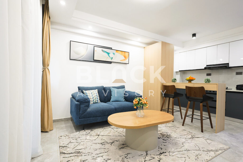 City Oasis Homes show apartment: sofa, coffee table and breakfast bar