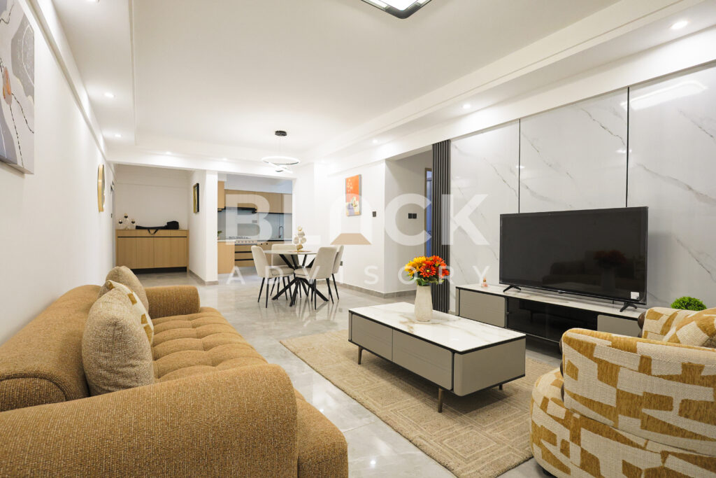 City Oasis Homes show apartment: living room with TV wall and dining area